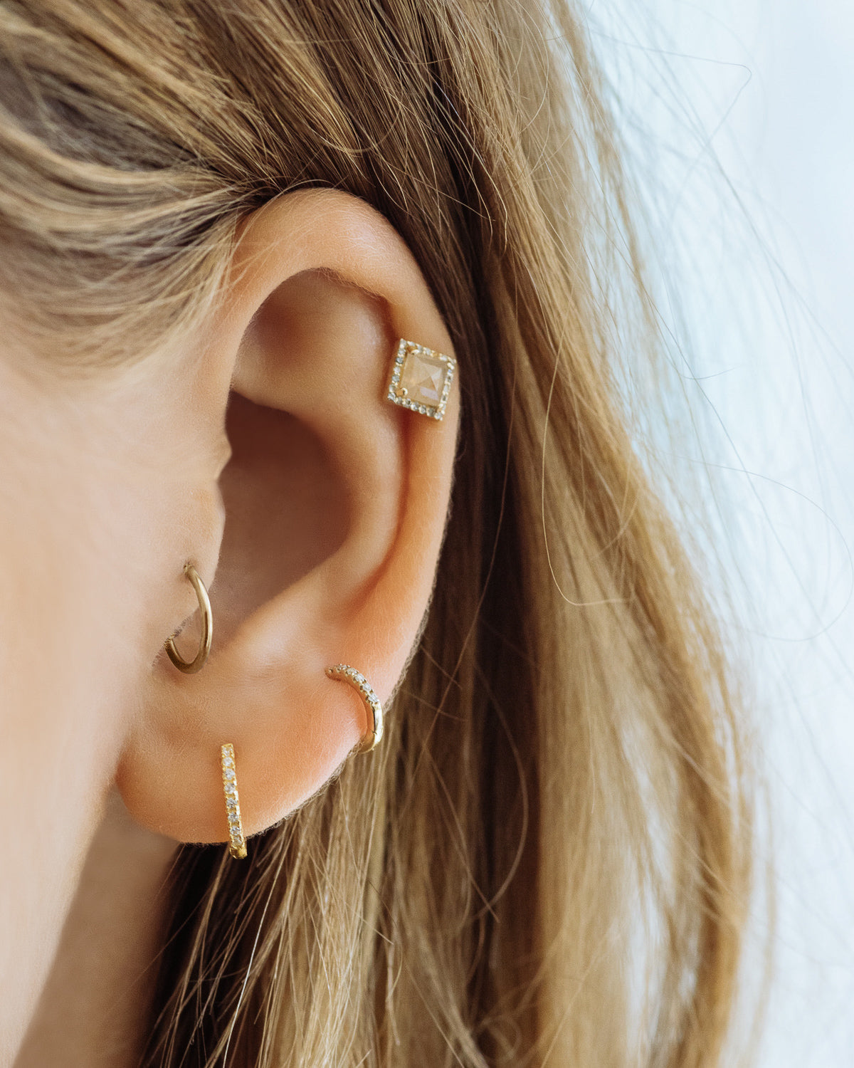 Sorrento Huggies - Rose Gold - Earrings — worn view